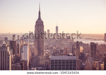New York City - USA. View to Lower Manhattan downtown skyline with famous Empire State Building and skyscrapers at sunset.