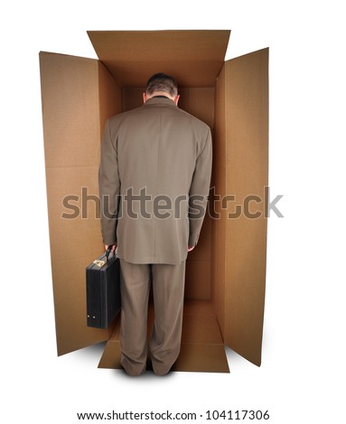 A trapped business man is walking into a brown box to represent a challenge or unemployment on a white background. The employee is wearing a suit. Royalty-Free Stock Photo #104117306