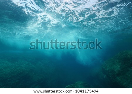 Sea foam formed by wave breaking on rock, seen from underwater, Mediterranean sea, Cote d'Azur, France Royalty-Free Stock Photo #1041173494