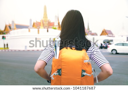 Traveler woman with backpack and map looking for Thai temple