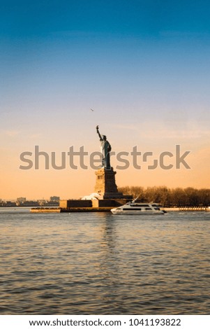 Amazing View of Statue of Liberty in New York City on the Background of Colorful Dawn Sky, Free Space for Text