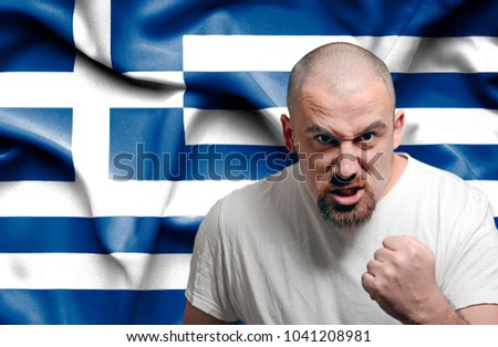 Angry man against flag of Greece