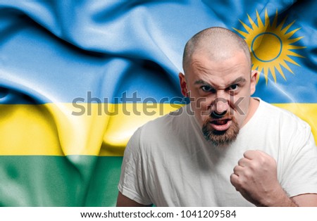 Angry man against flag of Rwanda