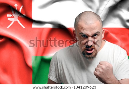 Angry man against flag of Oman