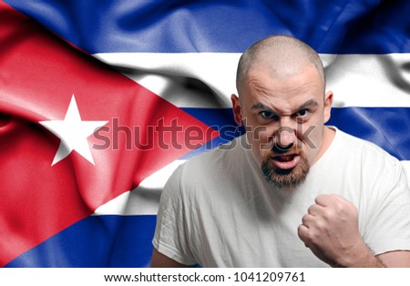 Angry man against flag of Cuba