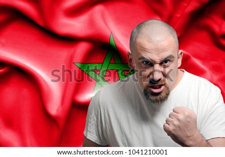 Angry man against flag of Morocco