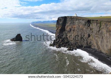 Sea coast near the Arch Dyrholaey in Iceland Royalty-Free Stock Photo #1041224173
