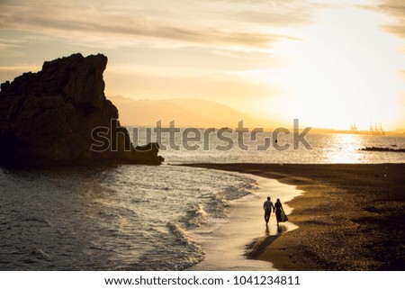 Young couple is  walking in Costa del Sol , Malaga, Spain Royalty-Free Stock Photo #1041234811