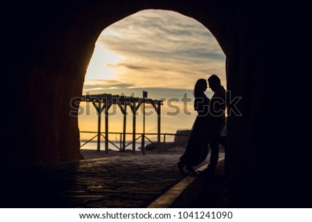 Couple kissing on the beach with a beautiful sunset in background, Malaga, Spain Royalty-Free Stock Photo #1041241090