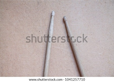 Horizontal photo of old used drumsticks on a light background