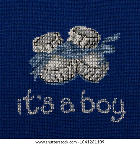 Blakint booties are embroidered on blue fabric. The inscription "It's a boy."