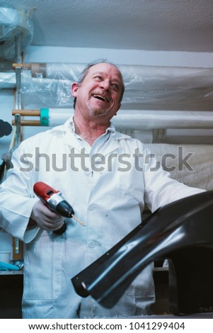  Portrait 59  year  old man working at the fiber workshop