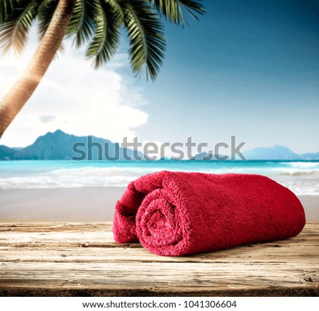 Summer photo of wooden desk and travel tools. Free space for your decoration. Blurred beach background. 
