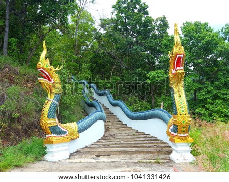A beautiful statue of Naga on the steps up the temple.