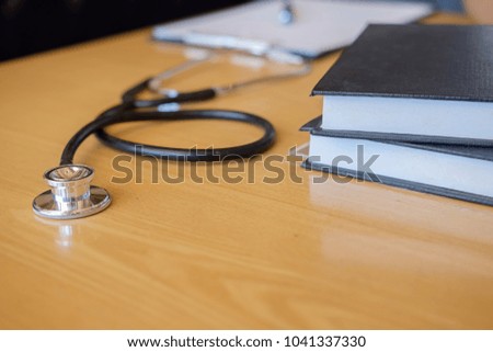 Stethoscope with clipboard and Laptop on desk Doctor working in hospital writing a prescription Healthcare and medical concept test results in background vintage color selective focus.
