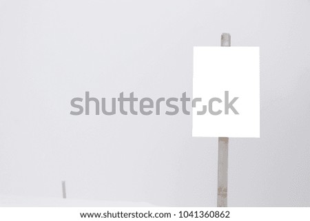 White sign in the forrest on a cloudy /foggy day in the alps .Snowy landscape 