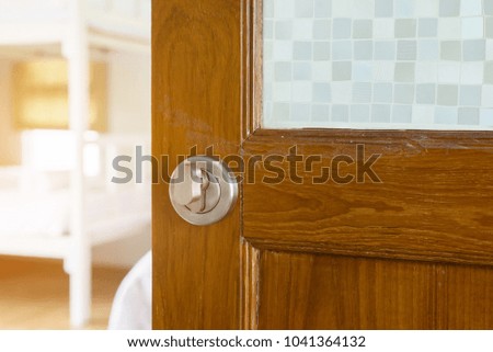 Old wooden door open with modern door handle and blur room blackground