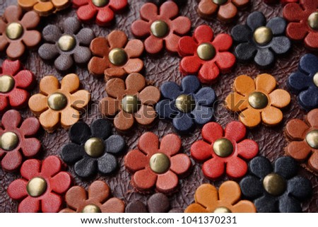Colorful flowers made from leather background. Handmade accessory decorative bag. Royalty-Free Stock Photo #1041370231