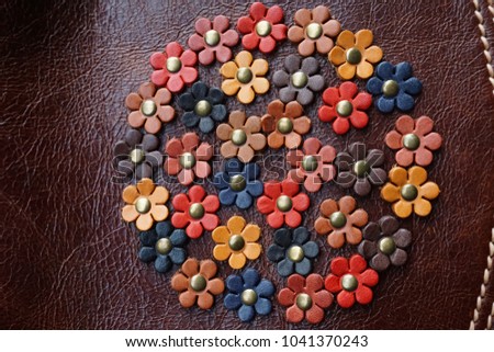 Colorful flowers made from leather background. Handmade accessory decorative bag. Royalty-Free Stock Photo #1041370243