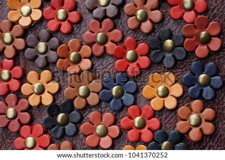 Colorful flowers made from leather background. Handmade accessory decorative bag. Royalty-Free Stock Photo #1041370252