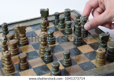 Hand holding queen chess game