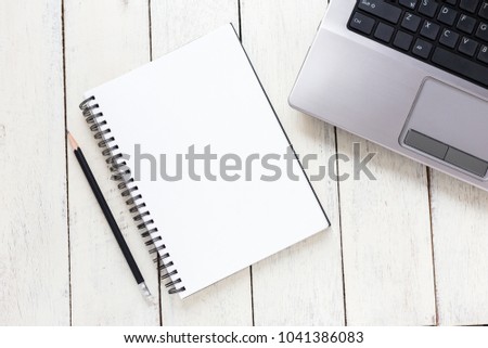 Empty notebook and computer  on white wooden table
