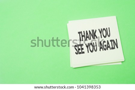 note paper written thank you and see you again over green background