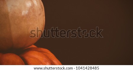 Cropped image of pumpkins arranged over black background