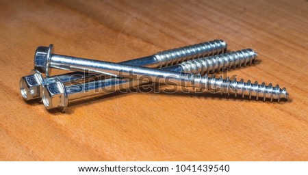 Self-tapping screws made of metal on a wooden surface