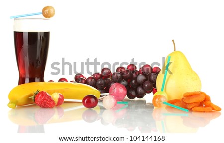 The composition of the lollipops, fruit and a glass of cola isolated on white