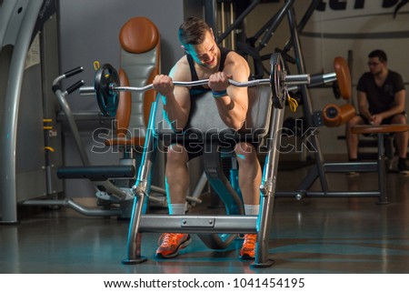 Young fitness model doing work in the gym