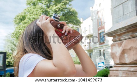 Beautiful tourist girl with vintage film camera