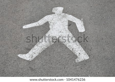 the figure of a man painted on the asphalt,
