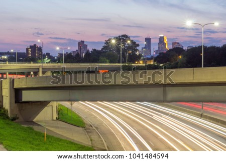 A Medium Shot Compressing Traffic with Distant Downtown Minneapolis on a Summer Twilight
