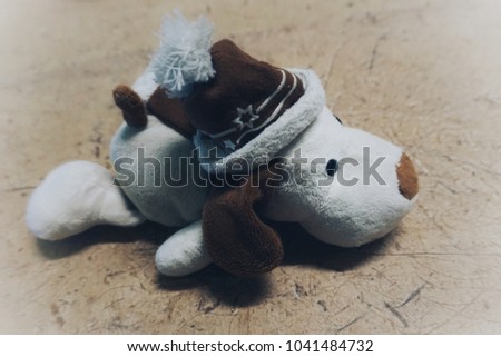 Cute dog doll wearing brown hat White body Have a sad mood Miss someone