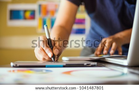 Graphic designer at studio work Creativity renovation and technology concept Color swatch samples for selection coloring on digital graphic tablet