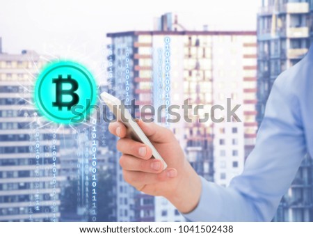 Digital composite of Bit coin icon and hand holding phone