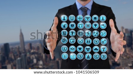 Digital composite of Various app icons and Businessman with hands palm open in city