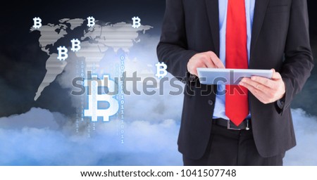 Digital composite of Bit coin icons on world map with man using tablet