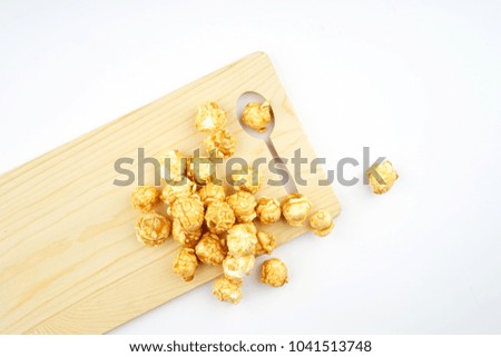 Entertainment or movie concept. Popcorns on a wooden board. Flat lay view.