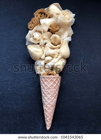 waffle cone with light brown roses. concept cappuchino bouquet of flowers in a waffle cone 