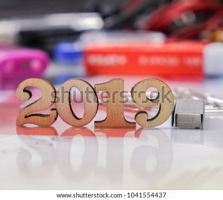 Wooden numbers year '2019' on a messy office desk