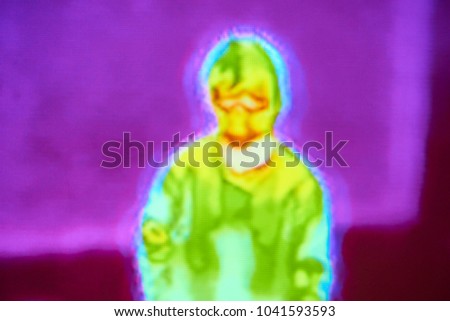 Blurred Thermographic image of the human child. Thermal Image Scanning for Influenza Border Screening in airport. Infrared thermal image scanners for the mass screening of travellers for influenza Royalty-Free Stock Photo #1041593593