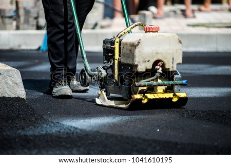 asphalt laying by workers Royalty-Free Stock Photo #1041610195