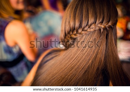 Hairdresser working at the beauty studio salon, making hair style. Royalty-Free Stock Photo #1041614935