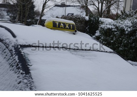 Taxi car covered with snow