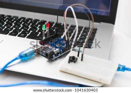 An electronic board that can be programmed. Robotics and electronics. Laboratory in the school. Mathematics, engineering, science, technology, computer code. STEM education for children.  Royalty-Free Stock Photo #1041630403