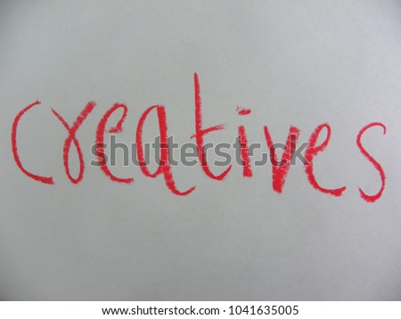 Text creatives hand written by red oil pastel on white color paper