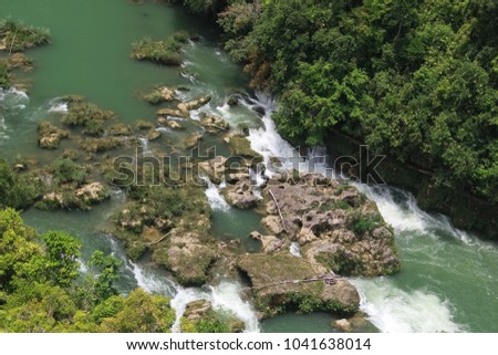 Mountainous stormy stream with rapids and stones flowing through the forest, no one, close up