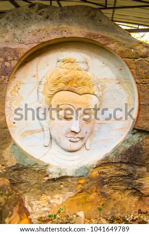Carving Buddha art on rock in Huai Pha Kiang temple, Thailand.